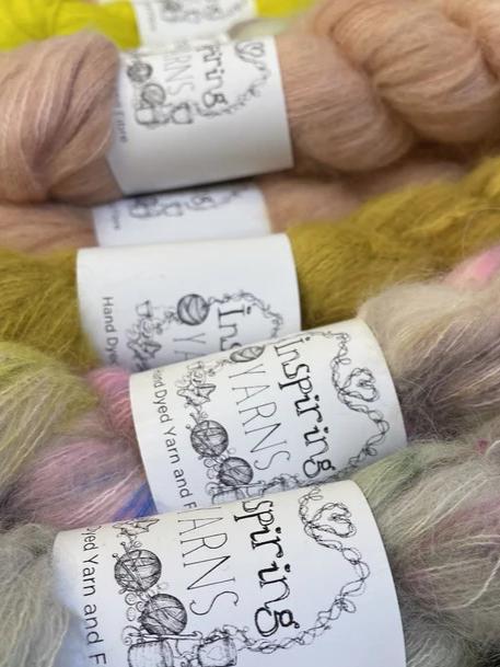 A selection of Inspiring Yarns hand dyed Brushed Suri Lace with branded yarn bands