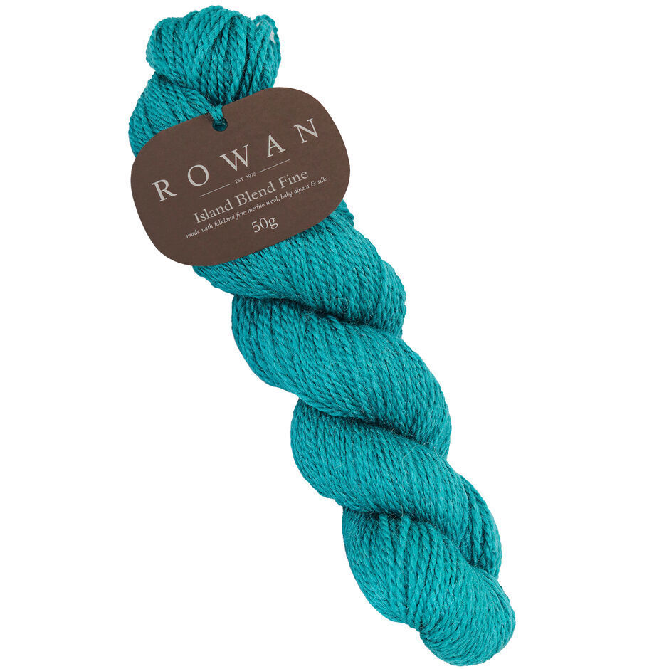 A skein of Rowan Island Blend Fine yarn in a teal, with the brand label showing the product name and weight.
