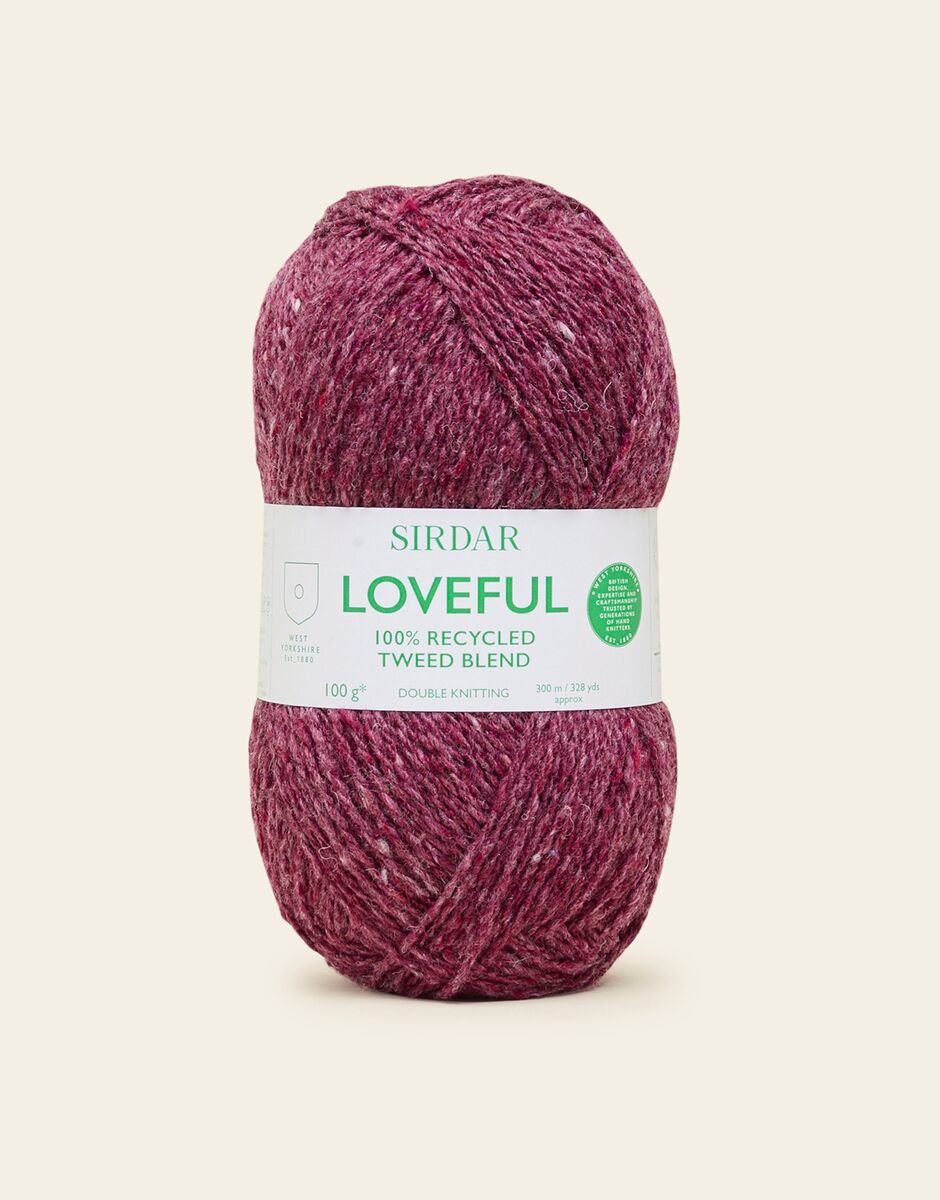 Ball of plum Sirdar Loveful yarn on a beige background