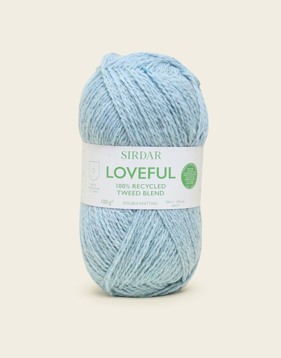 Light blue skein of yarn with a Sirdar loveful label on a light beige background