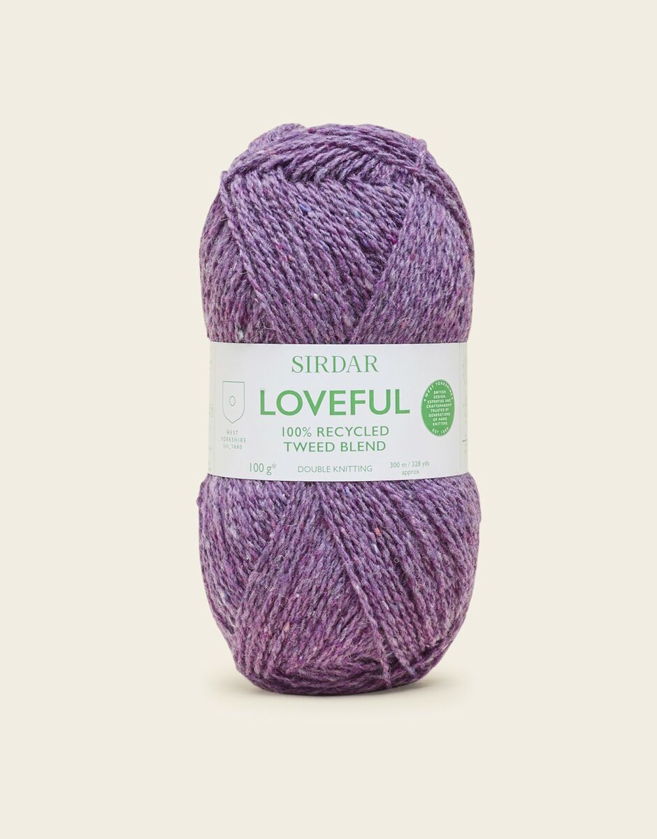 Purple skein of yarn with a Sirdar label on a light beige background