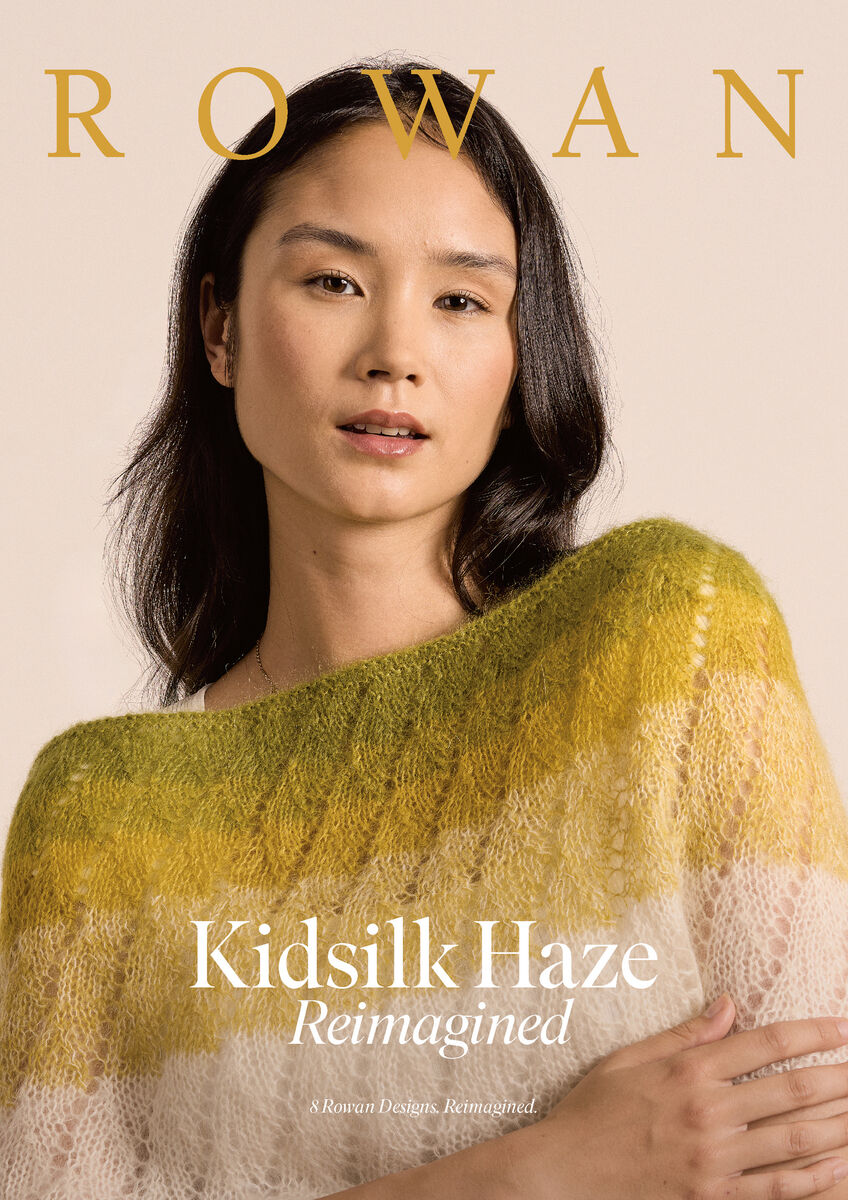 Woman wearing a green and beige knitted shawl with 'Rowan' branding on a beige background.