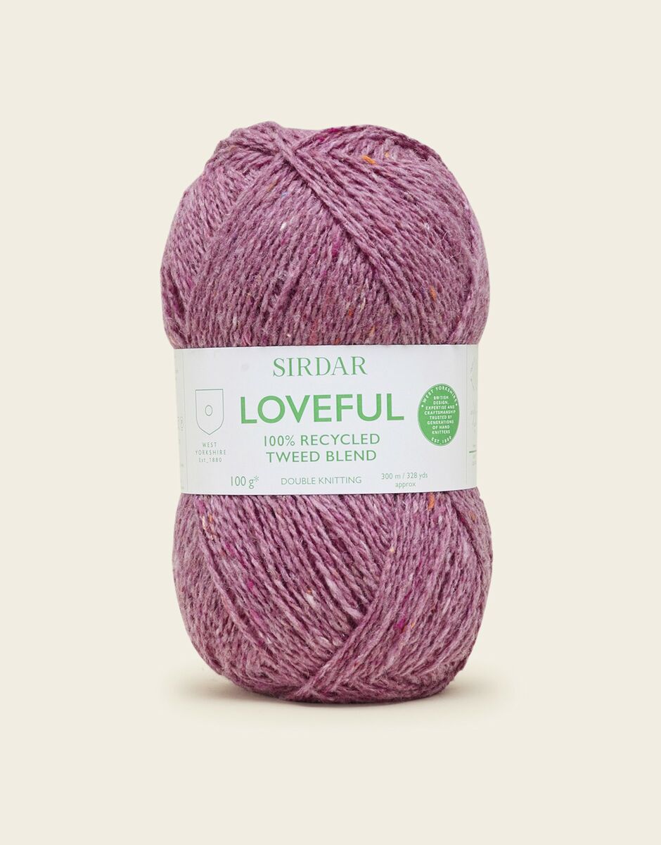 Ball of pink yarn with a Sirdar label on a light beige background