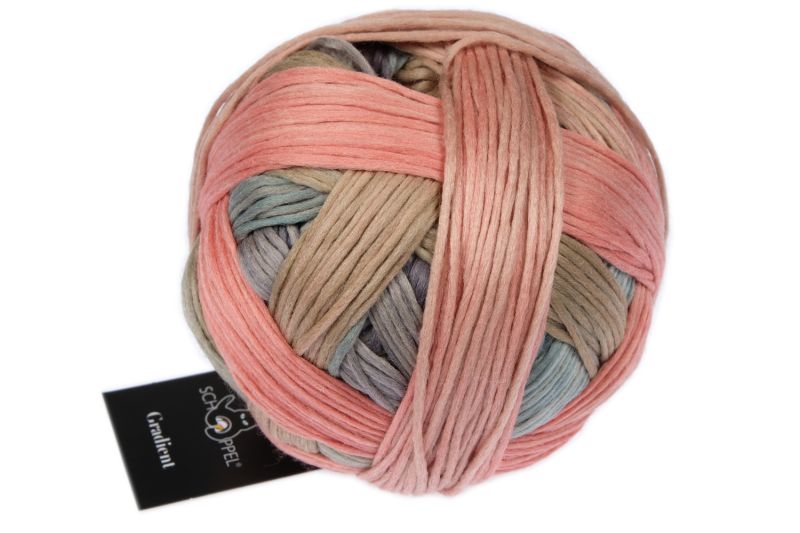 Image shows wound ball of Schoppel Gradient DK yarn. Colourway is 2624 Mousse Test/Elchtest in shades of pale peach, green and blue.