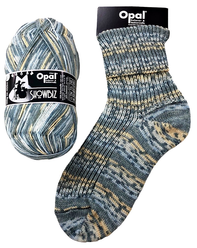 Opal Showbiz yarn ball and sock in neutral tones of blue grey and yellow on a white background