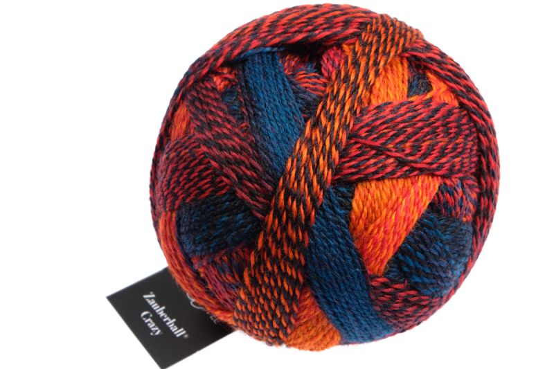 Image shows wound ball of Schoppel Zauberball Crazy 4ply/sock.  The colour is 1537 Autumn Sun/Herbstonne, in shades of orange and blue.