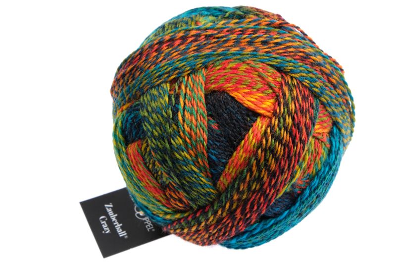 Image shows wound ball of Schoppel Zauberball Crazy 4ply/sock.  The colour is 1564 Tropical Fish/Frische Fische, in shades of orange, green, yellow and blue.