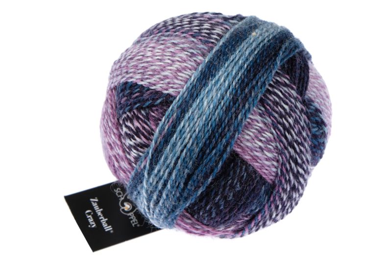Image shows wound ball of Schoppel Zauberball Crazy 4ply/sock.  The colour is 1669 Lilac Scent/Fliederduft,  with shades of lilac, blue, purple abd light grey.