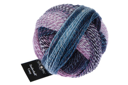 Image shows wound ball of Schoppel Zauberball Crazy 4ply/sock.  The colour is 1669 Lilac Scent/Fliederduft,  with shades of lilac, blue, purple abd light grey.