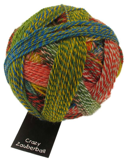 Image shows wound ball of Schoppel Zauberball Crazy 4ply/sock.  The colour is 1701 Parrot/Papagei,  with shades of green, yellow, blue and orange.