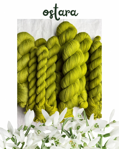 Skeins of green yarn with white flowers at the bottom on a light background, featuring the word 'ostara'.