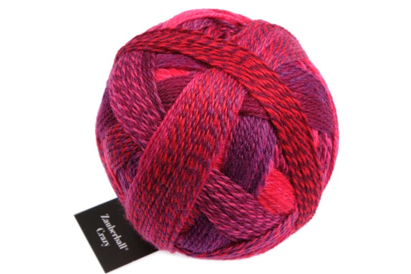 Image shows wound ball of Schoppel Zauberball Crazy 4ply/sock.  The colour is 2095 Indian Red/Indisch Rosa, with shades of coral, purple and pink