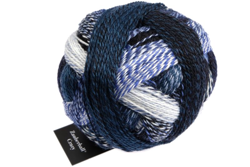 Image shows wound ball of Schoppel Zauberball Crazy 4ply/sock.  The colour is 2099 Blue Break/Pause in Blau, with shades of light, medium and dark blue, and off-white.