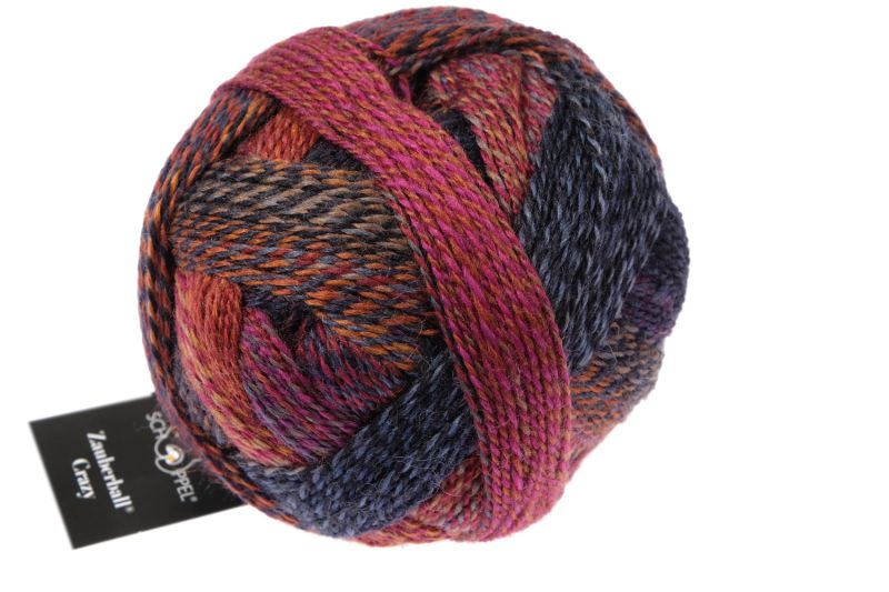 Image shows wound ball of Schoppel Zauberball Crazy 4ply/sock.  The colour is 2248 Cinnamon Bun/Zimtschnecke,  with shades of orange, rust and slate blue.