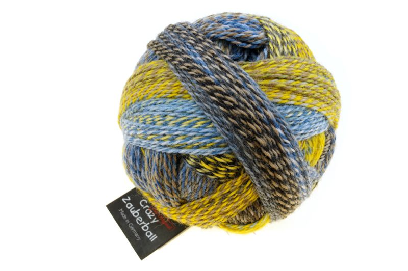 Image shows wound ball of Schoppel Zauberball Crazy 4ply/sock.  The colour is 2332 Hour Glass/Sanduhr  with shades of yellow, blue  and neutrals.