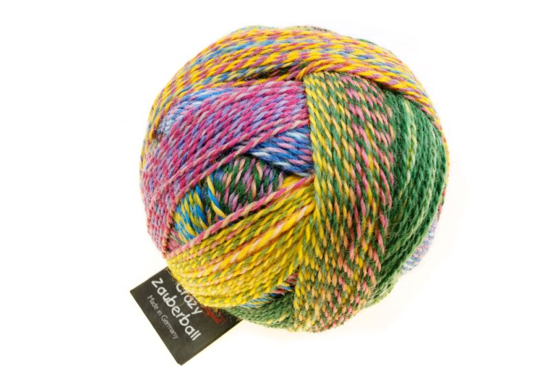 Image shows wound ball of Schoppel Zauberball Crazy 4ply/sock.  The colour is 2334 Malerwinkel, with shades of yellow, green, pink and blue.
