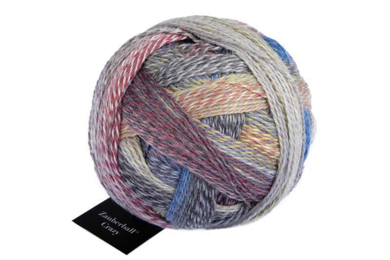 Image shows wound ball of Schoppel Zauberball Crazy 4ply/sock.  The colour is 2427 Foehn Weather/Fuhnlage, with shades of grey, pink, lemon, blue and neutrals.