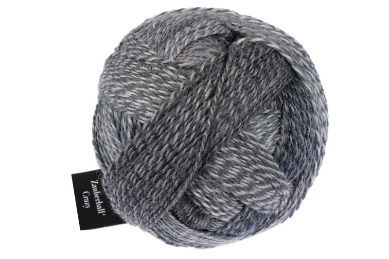 Image shows wound ball of Schoppel Zauberball Crazy 4ply/sock.  The colour is 2428 Mud Pack/Schlammpackung, with shades of dark and light greys,