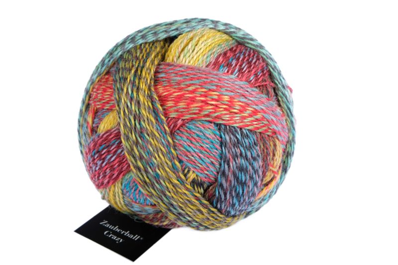 Image shows wound ball of Schoppel Zauberball Crazy 4ply/sock.  The colour is 2429 Chaange of Scenery/Tapetenweschsel, with shades of coral, yellow, blue/grey.