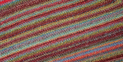 Image shows knitted swatch for Schoppel Zauberball Crazy 4ply/sock.  The colour is 2429 Chaange of Scenery/Tapetenweschsel, with shades of coral, yellow, blue/grey.