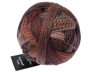 Image shows wound ball of Schoppel Zauberball Crazy 4ply/sock.  The colour is 2544 Late Autumn by Kieran Foley, with shades of brown, grey and neutrals.