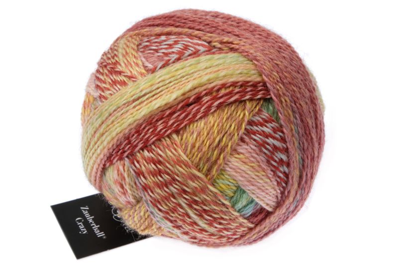 Image shows wound ball of Schoppel Zauberball Crazy 4ply/sock.  The colour is 2545 Early Autumn by Kieran Foley, with shades of tan, yellow and light blue.