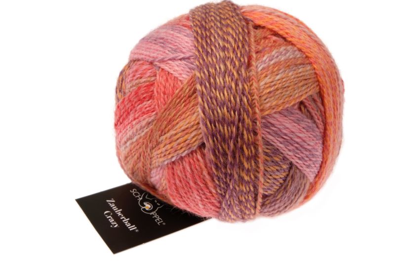 Image shows wound ball of Schoppel Zauberball Crazy 4ply/sock.  The colour is , with shades of peach, pink and mauve.