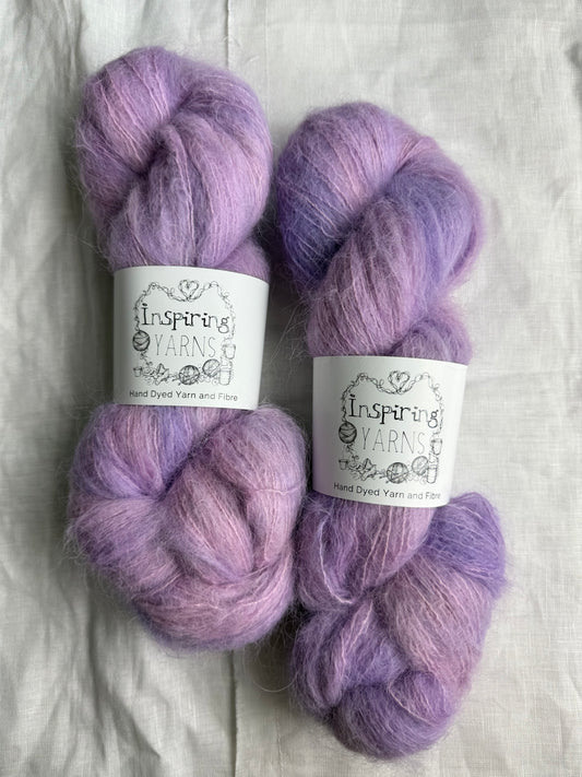 pale pink and lilac yarn with inspiring yarns labels and white background.