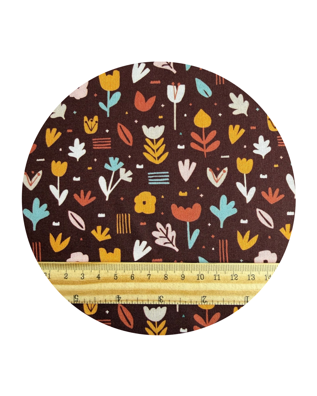 A round swatch of Flower Bed Brick from Jungle Dreams Collection for Cloud9 Fabrics, and a wooden ruler in centimeters for scale on a white background.