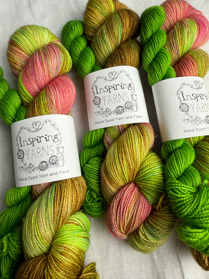 three sets of yarn in sock sets with colours such as lime green pink brown and yellow.