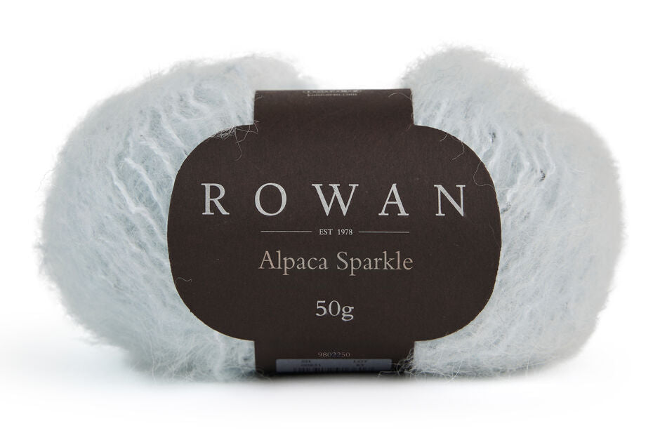 ball of rowan alpaca sparkle with black rowan label with grey writing on plain white background.