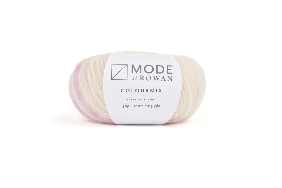 ball of cream and blush pink yarn with  mode at rowan label on a plain white background. 
