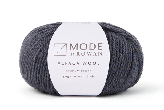 ball of dark grey yarn wih mode at rowan label on a plain white background.