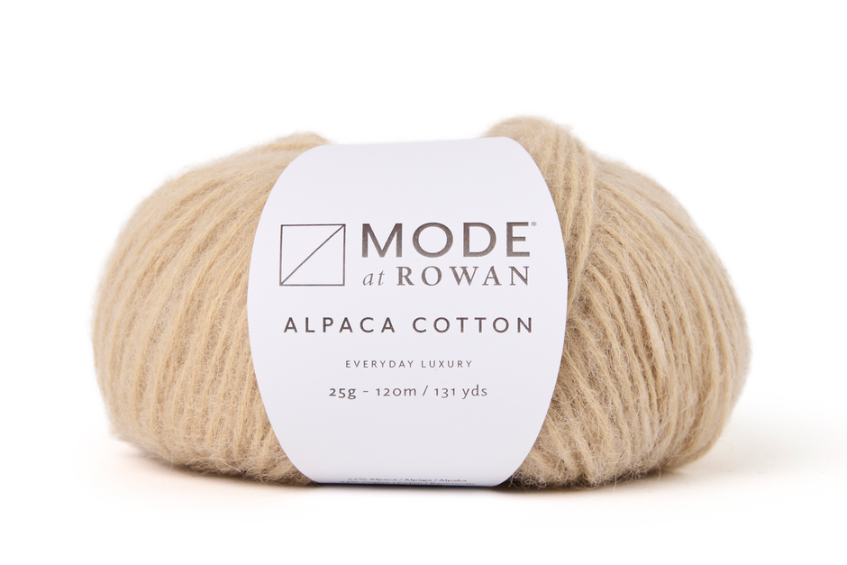 beige ball of yarn with white mode at rowan label with grey writing on a plain  white background.