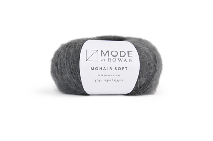 ball of grey yarn with white mode at rowan label with grey writing. on a plain white background.