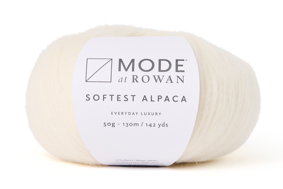 ball of natural white cream yarn with mode at rowan label on a white background.
