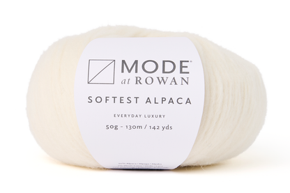 ball of natural white cream yarn with mode at rowan label on a white background.