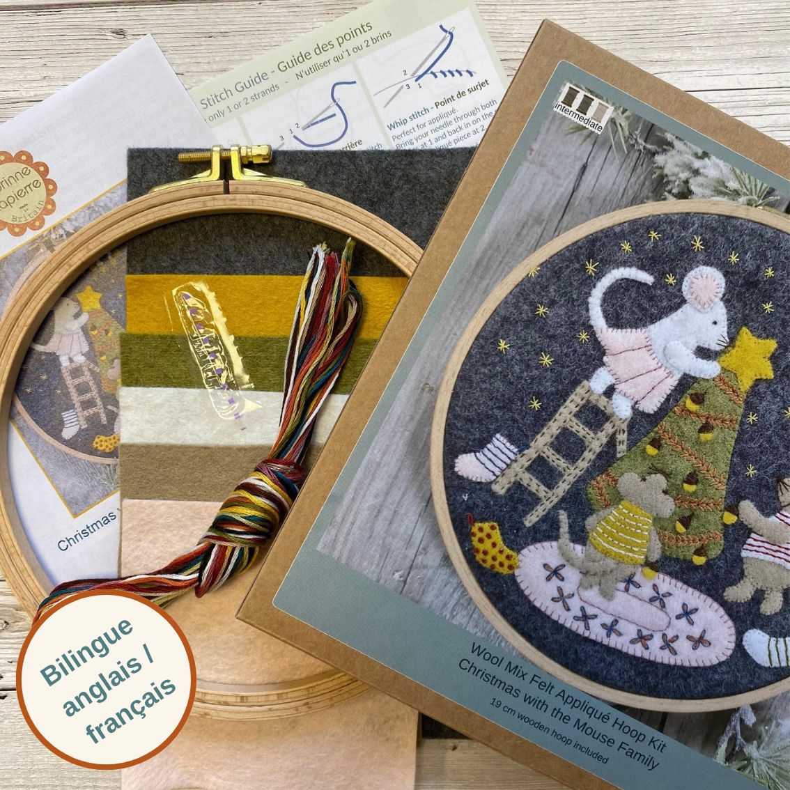 Embroidery hoop kit with Christmas-themed design and instructions on a wooden surface.