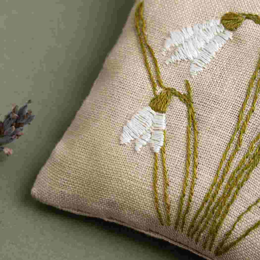 up close of white embroidered snow drop.