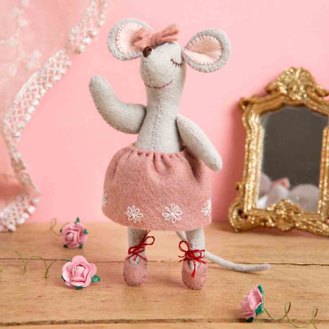 decorative felt ballerina mouse in a pink dress with flowers and a mirror in the background.