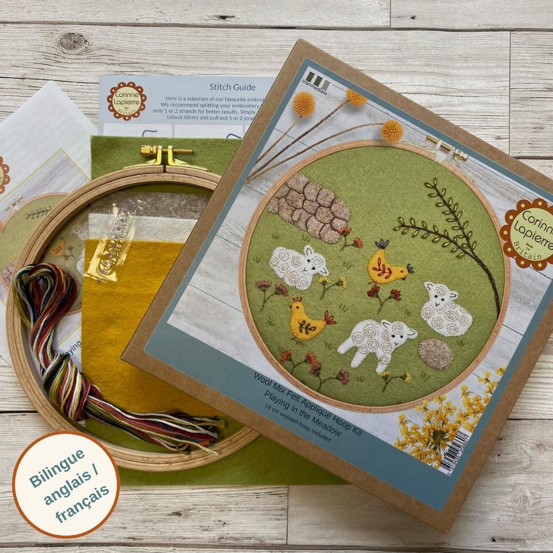 Embroidery kit with hoop, thread, and stitched design on a wooden surface