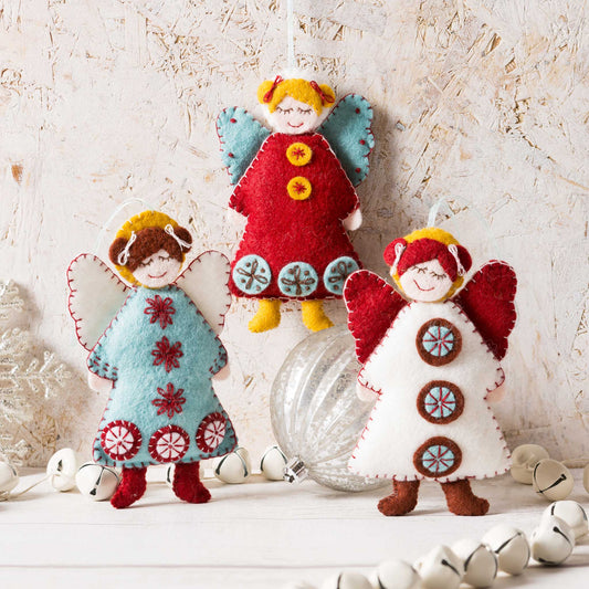 three felt Scandinavian angels in blues, reds and white.