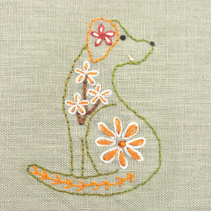 green dog outline in green and yellow  with different coloured floral designs.