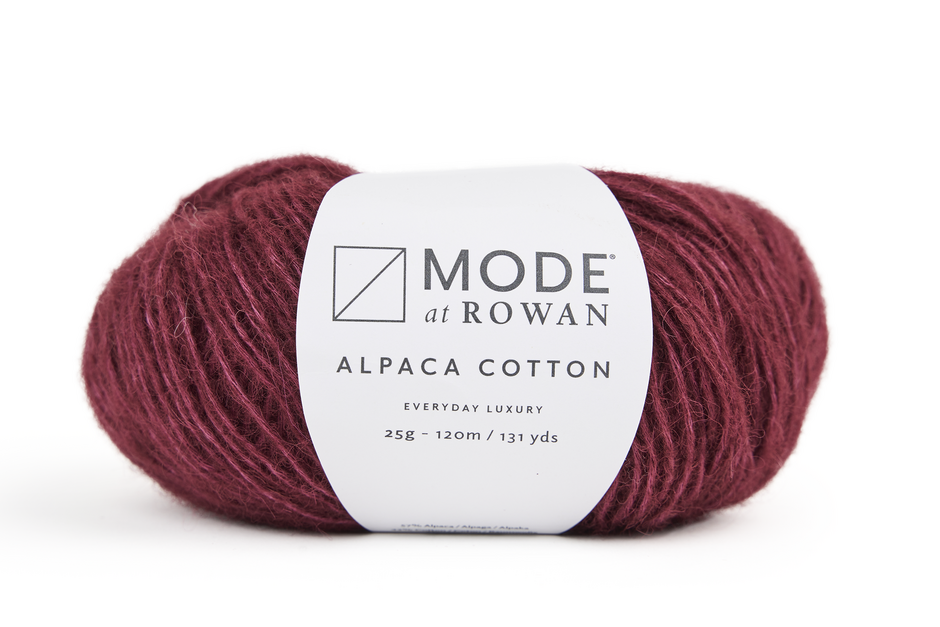 Ball of red yarn with a mode at rowan label with grey writing on a plain white background. 