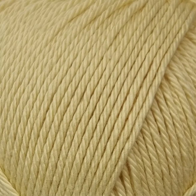 close up of light yellow cotton yarn ball.