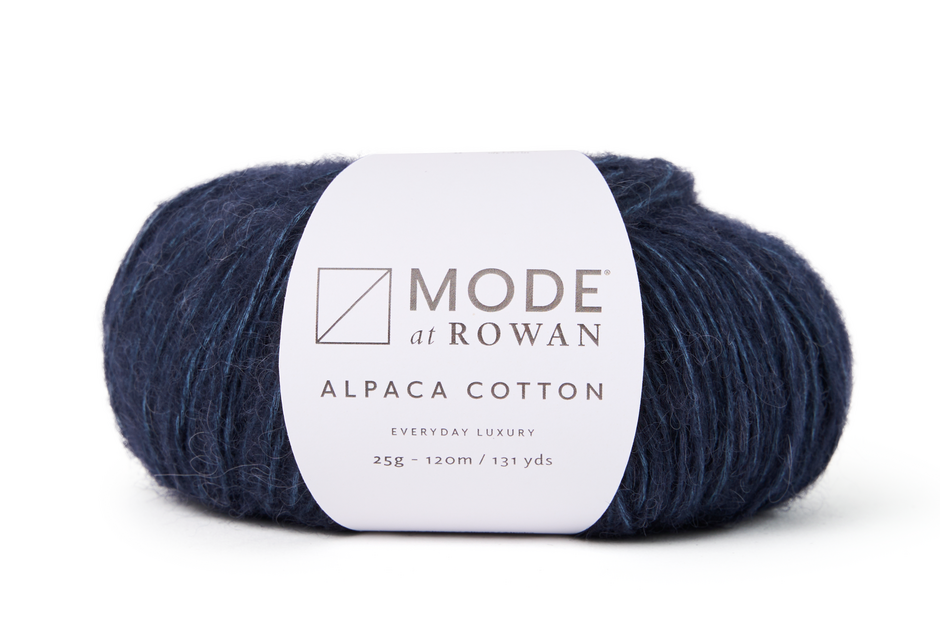 Dark blue yarn with white mode at rowan label with grey writing and a plain white background.