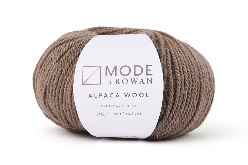 brown ball of yarn with mode at rowan label and ehite background.