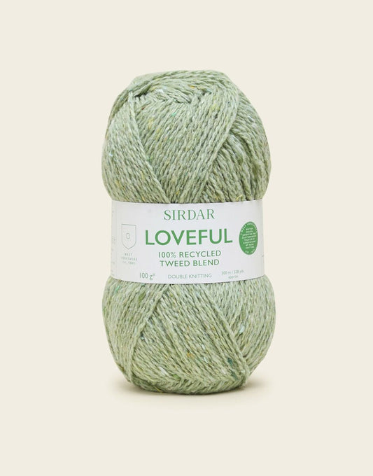 Green skein of yarn with a Sirdar label on a light beige background