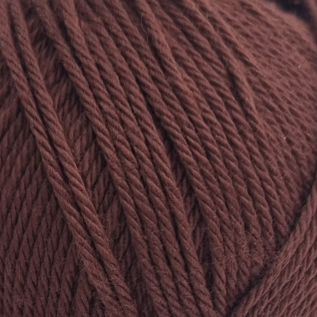 close up of deep  brown cotton balls of cotton yarn.