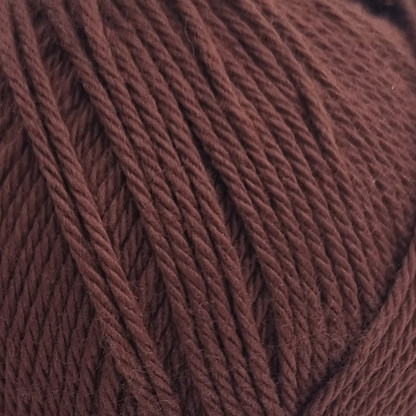 close up of deep  brown cotton balls of cotton yarn.